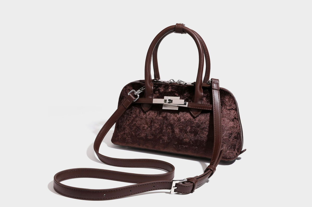 Small structured satchel bag in dark brown velvet-like textured finish with leather-look trim, silver-tone turn-lock bar
