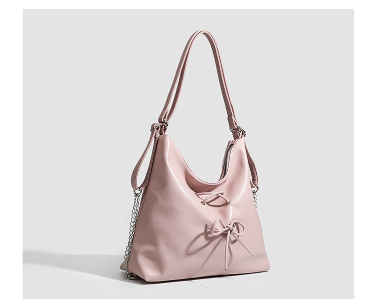 Glossy leather-look hobo shoulder bag with front bow lacing detail and silver-tone chain strap, detail view 14