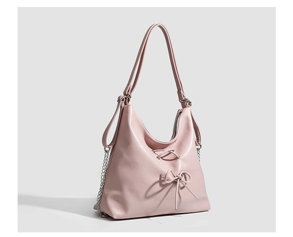 Glossy leather-look hobo shoulder bag with front bow lacing detail and silver-tone chain strap, detail view 14