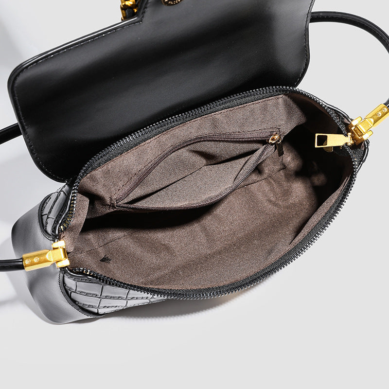 Crocodile-embossed leather-look baguette shoulder bag with gold-tone chain buckle closure and single shoulder strap, detail
