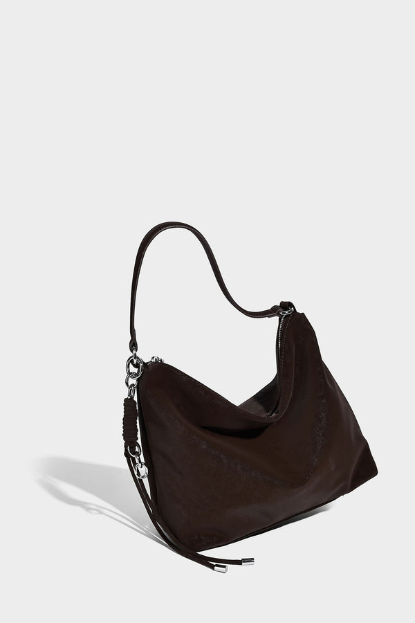 Slouchy matte-finish hobo shoulder bag with tassel cords, silver-tone hardware, and faux-fur pom charm, detail view 15