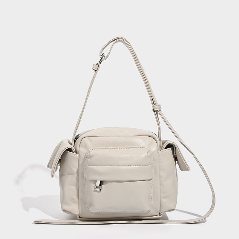 Boxy leather-look crossbody bag with front zip pockets, top zip closure, and long adjustable strap, detail view 8