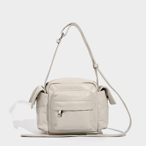 Boxy leather-look crossbody bag with front zip pockets, top zip closure, and long adjustable strap, detail view 8