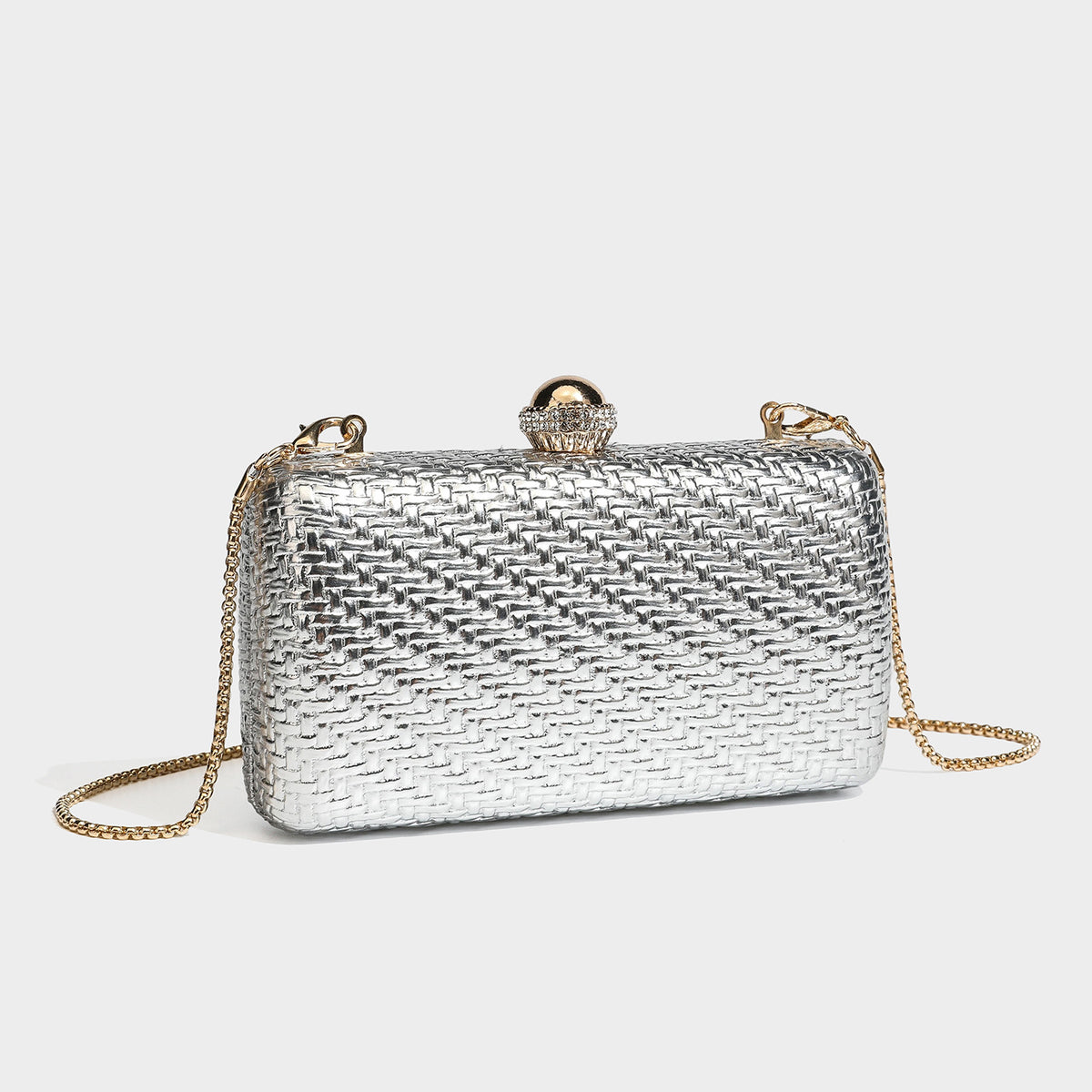 Small structured metallic woven-texture box clutch bag with jeweled kiss-lock dome clasp and slim gold chain strap, front