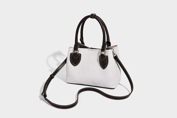 Structured light-blue denim-look tote bag with black leather-look handles, white contrast stitching, silver-tone hardware