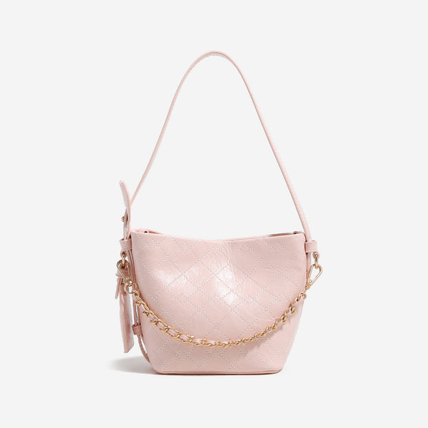 Small diamond-quilted bucket bag with gold-tone chain accent, heart strap detail, hanging tag, and matching zip coin pouch