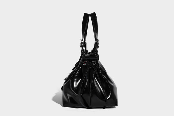 Glossy patent-look slouchy tote bag with ruched drawstring sides, dual top handles, silver ring hardware, and detachable