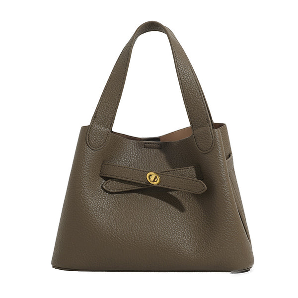 Pebbled trapezoid tote bag with gold turn-lock strap detail and matching snap pouch, detail view 5