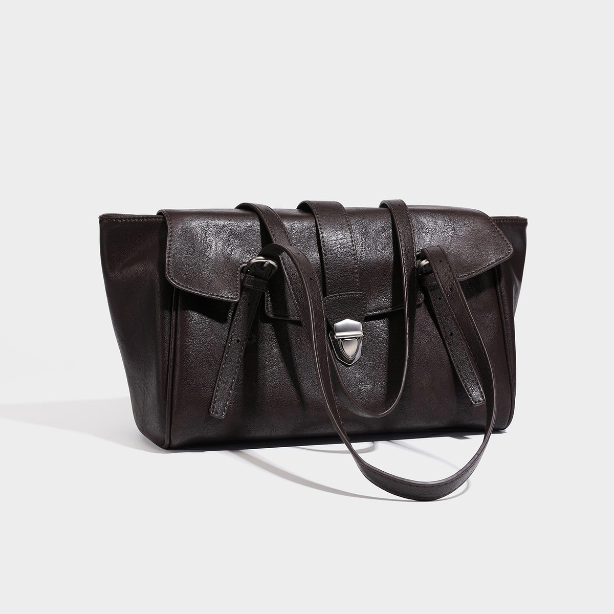 Large structured vintage-style tote bag with flap-front turn-lock closure, twin buckle straps, and double shoulder handles