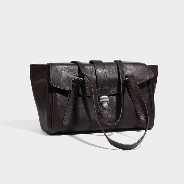 Large structured vintage-style tote bag with flap-front turn-lock closure, twin buckle straps, and double shoulder handles