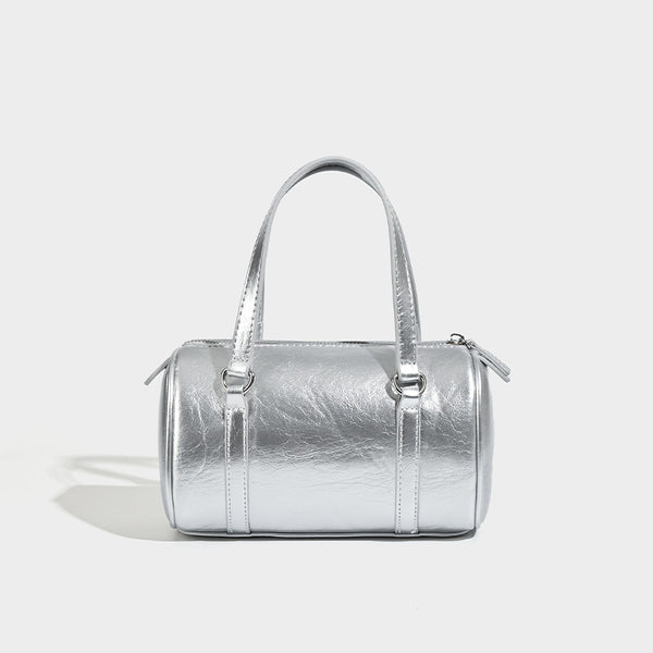 Mini silver barrel bag with crinkled leather-look finish, top handles, and silver-tone hardware, front view