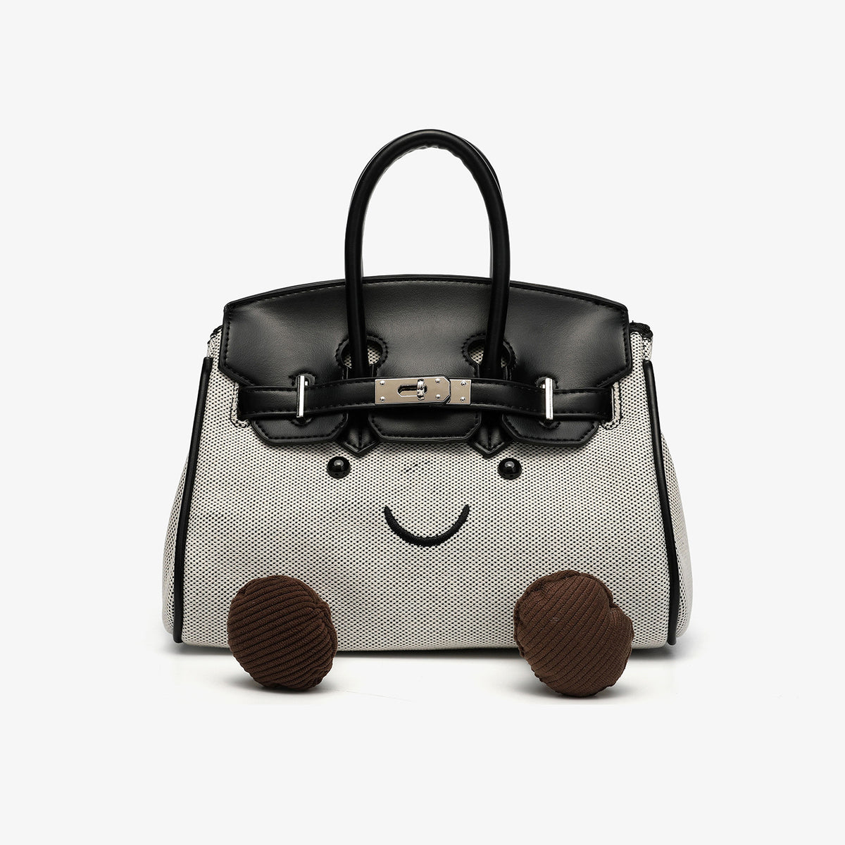 Small structured trapezoid satchel bag with smiling face motif, pom-pom accents, brown leather-look trim, silver-tone, detail