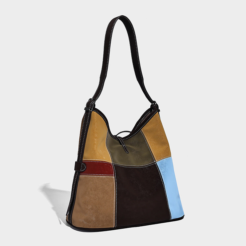 Patchwork bucket tote shoulder bag with tan, dark brown, olive, red, and sky blue color-block panels, white contrast, detail