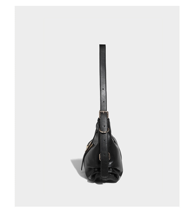 Soft slouchy hobo shoulder bag with smooth leather-look finish, gold-tone buckle and tab hardware, and long adjustable strap