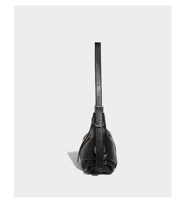 Soft slouchy hobo shoulder bag with smooth leather-look finish, gold-tone buckle and tab hardware, and long adjustable strap