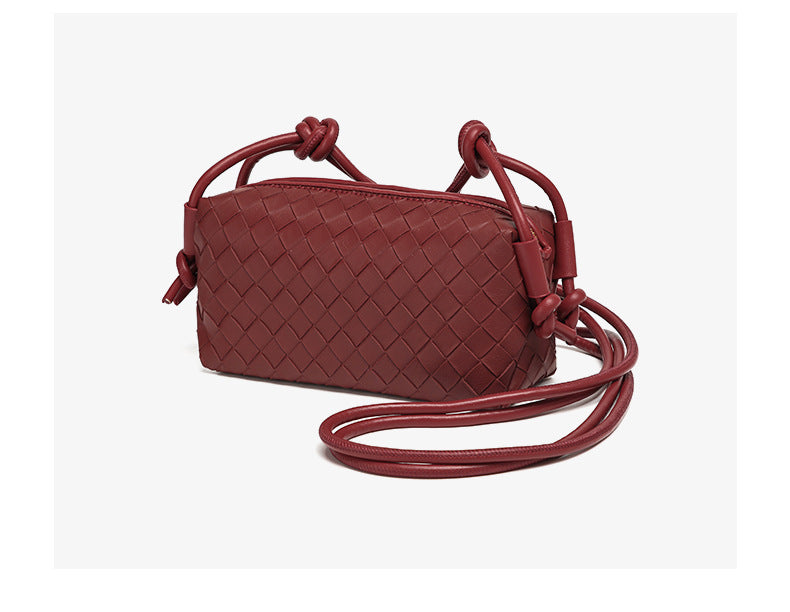 Small rectangular woven-texture mini crossbody bag with knotted rope strap and gold-tone zip closure, detail view 18