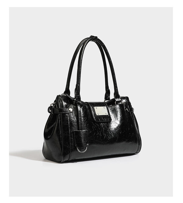 Structured glossy crinkled leather-look satchel with double top handles, front metal-plaque tab, silver-tone hardware, and