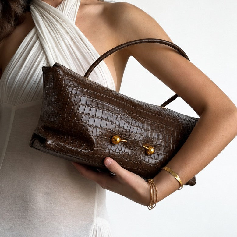 Wide embossed-texture shoulder tote bag with single loop handle and gold-tone toggle hardware, detail view 4