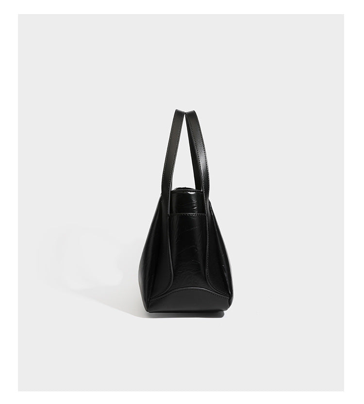 Black glossy crinkled leather-look convertible shoulder tote bag with gold gourd-shaped emblem hardware and detachable
