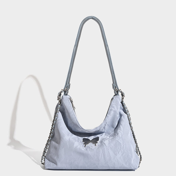Crinkle-finish hobo shoulder bag with silver-tone chain side panels and butterfly embellishment, front view