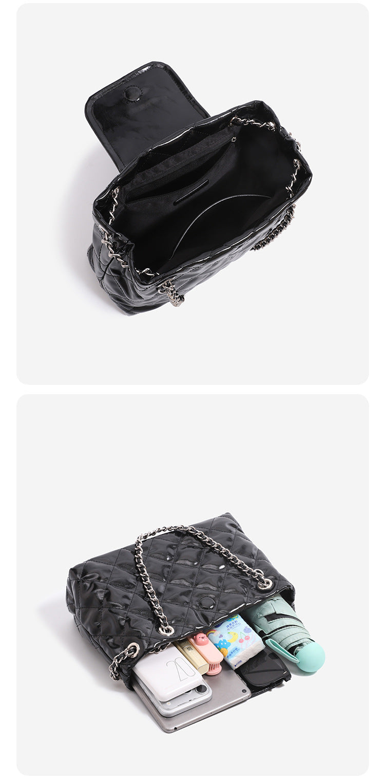 Structured diamond-quilted glossy black shoulder tote bag with interwoven silver chain strap and front flap snap pocket
