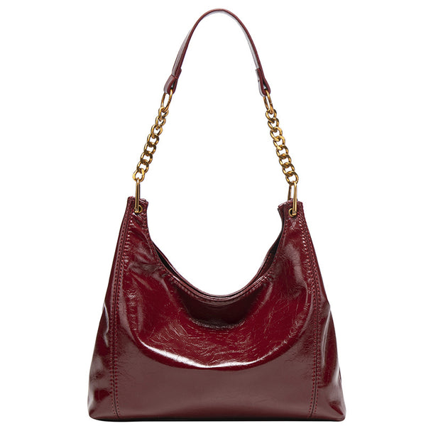 Glossy leather-look hobo shoulder bag with gold-tone chain-and-leather strap in deep burgundy red, detail view 5