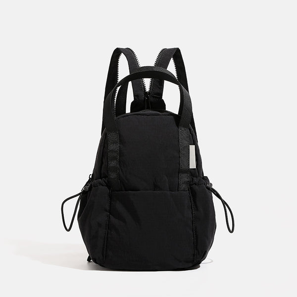 Small rounded mini backpack handbag in matte ripstop-texture fabric with top webbing handle, front pocket, side drawstring