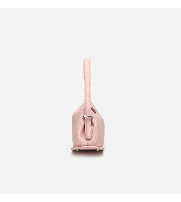 Pebbled leather-look half-moon saddle bag with turn-lock flap closure, top handle, and detachable crossbody strap, detail
