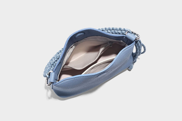 Small crescent half-moon bag in pebbled leather-look finish with braided top handle, silver-tone ring hardware, and, detail