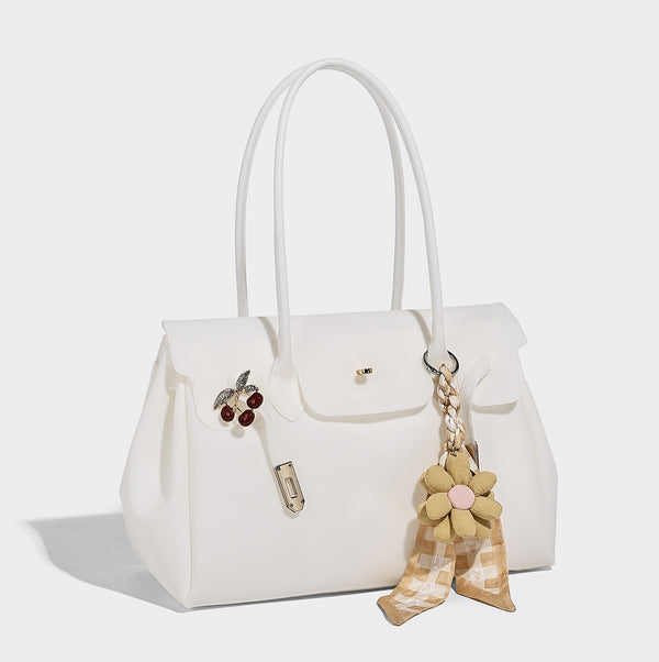 Strukturierte Tote-Bag aus mattem Jelly-Material mit goldfarbenem Klappverschluss mit Drehverschluss, zwei Schulterhenkeln, seitlichen Zwickeln und dekorativer