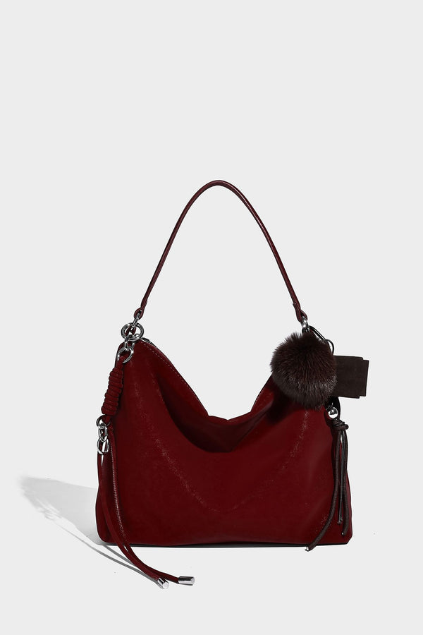 Slouchy matte-finish hobo shoulder bag with tassel cords, silver-tone hardware, and faux-fur pom charm, detail view 29