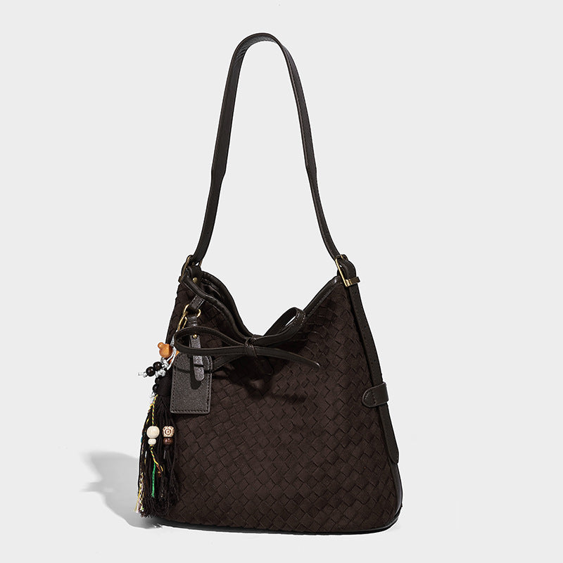 Dark brown woven-texture bucket bag with tie-knot closure, gold-tone hardware, and adjustable shoulder strap, front view