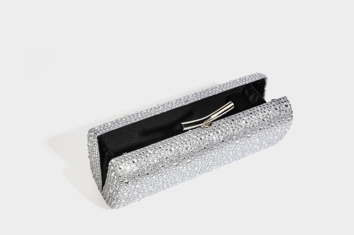 Structured rectangular hard-case clutch bag covered in all-over rhinestone crystal embellishment with curved kiss-lock top