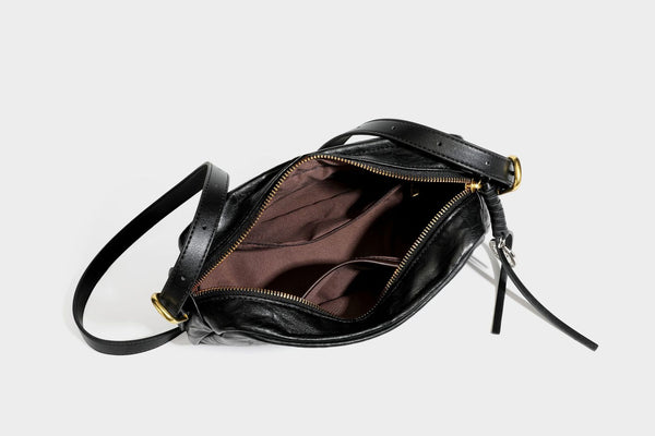 Compact black crinkled leather-look baguette shoulder bag with gold-tone arch hardware and adjustable strap, detail view 36