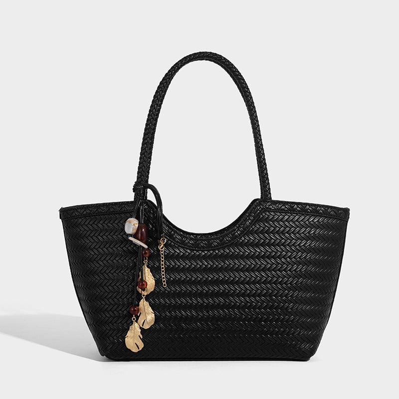 Large open-top woven tote bag with contrasting braided double handles and matching drawstring pouch, detail view 3