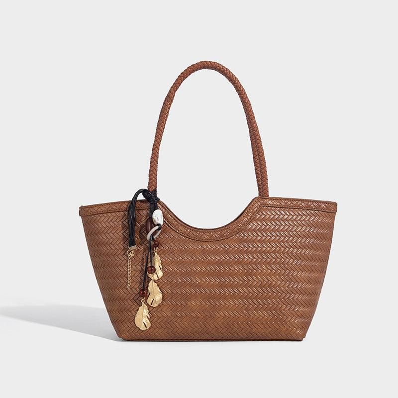 Large open-top woven tote bag with contrasting braided double handles and matching drawstring pouch, detail view 7