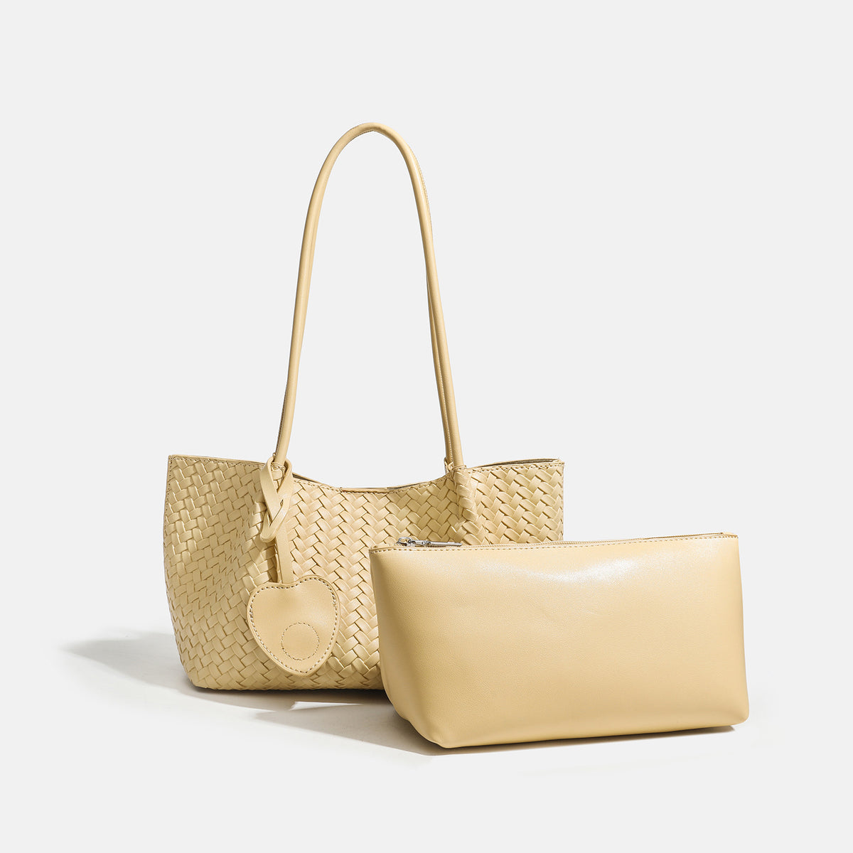 Woven leather-look tote bag in yellow with long shoulder straps, heart-shaped hanging charm, and removable inner zip pouch