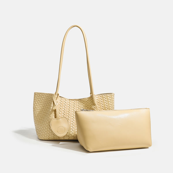 Woven leather-look tote bag in yellow with long shoulder straps, heart-shaped hanging charm, and removable inner zip pouch