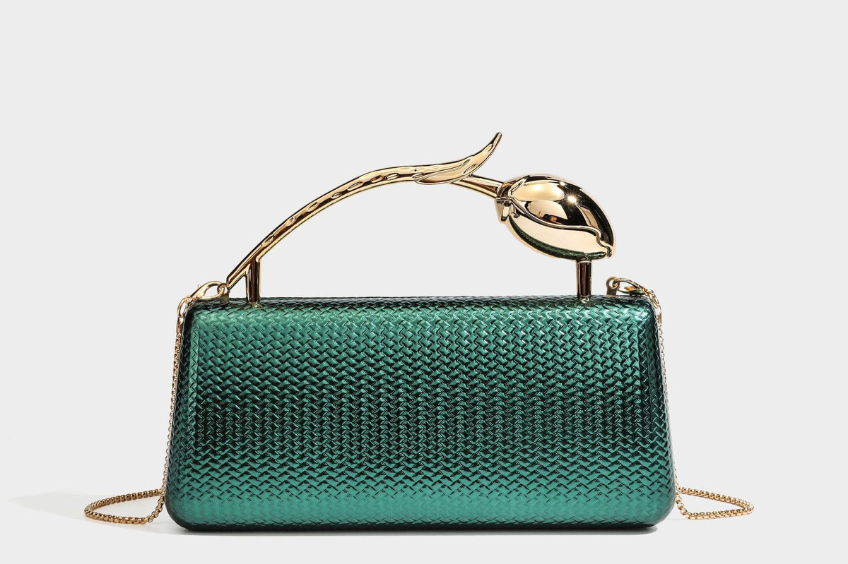 Structured rectangular metallic woven clutch bag with sculptural gold-tone leaf top handle and detachable chain strap, detail