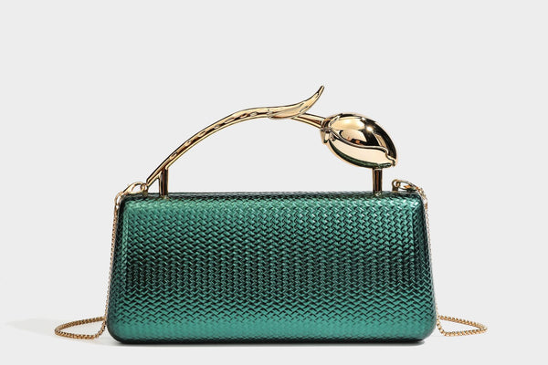 Structured rectangular metallic woven clutch bag with sculptural gold-tone leaf top handle and detachable chain strap, detail