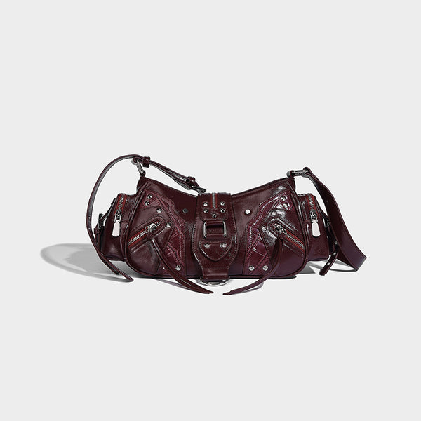 Compact glossy leather-look crossbody bag with silver studs, buckle hardware, and multiple zip pockets, detail view 7