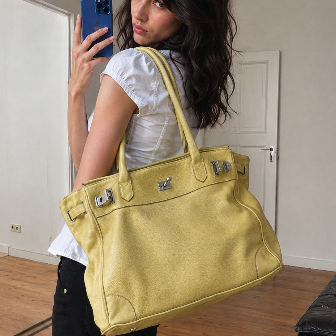 Large structured tote bag with turn-lock closure, silver-tone buckle hardware, and twin rolled handles, front view