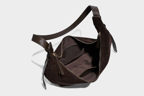 Slouchy crescent hobo shoulder bag in dark chocolate matte suede-look finish with adjustable strap and twin-pull top zip