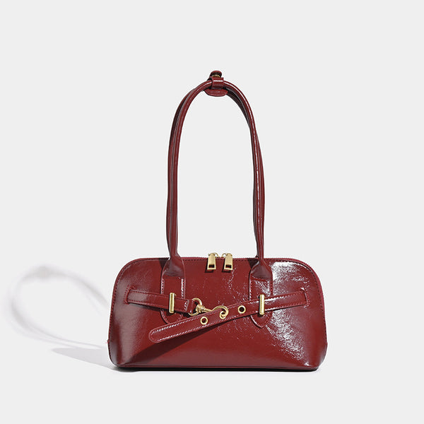 Small structured glossy leather-look shoulder bag with gold-tone buckle hardware and twin top handles, detail view 6