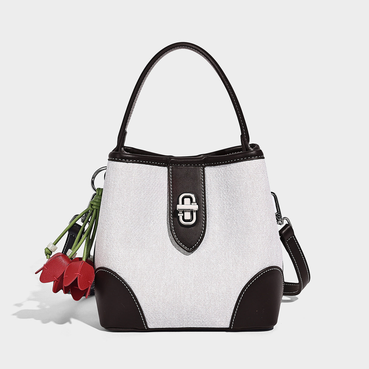 Small structured bucket bag in denim-look light blue fabric with black leather-look trim, silver turn-lock hardware, short