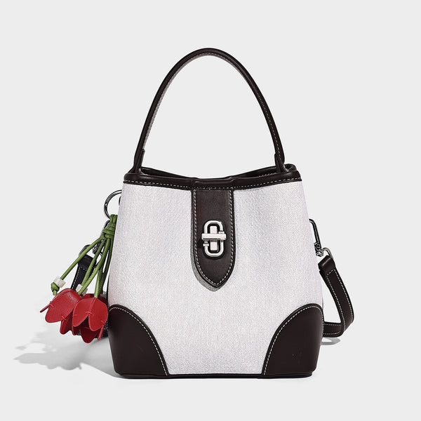 Small structured bucket bag in denim-look light blue fabric with black leather-look trim, silver turn-lock hardware, short