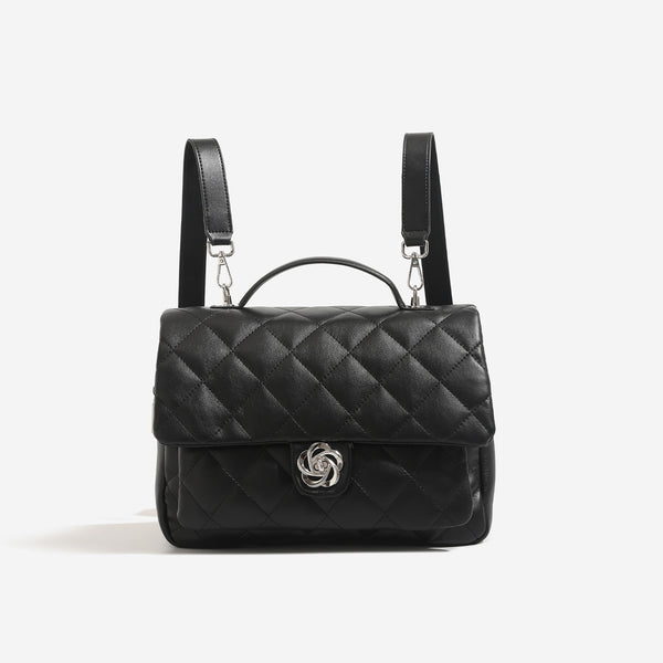 Diamond-quilted flap backpack handbag with silver-tone flower turn-lock, top handle, and dual shoulder straps, detail view 6