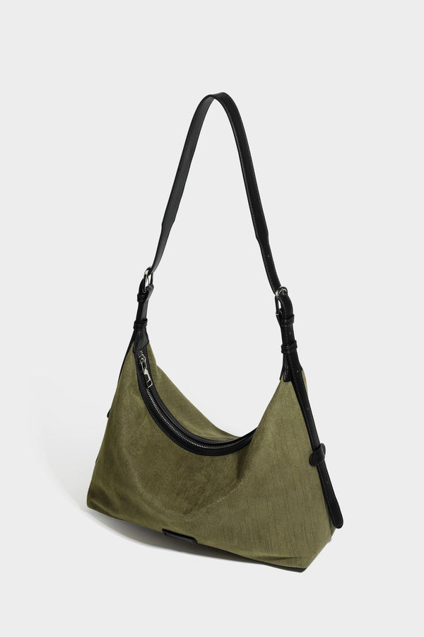 Slouchy olive green canvas hobo shoulder bag with black leather-look trim, zip-top closure, and adjustable strap, detail view