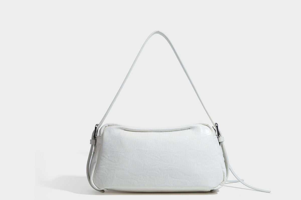 Compact black crinkled leather-look baguette shoulder bag with gold-tone arch hardware and adjustable strap, detail view 23