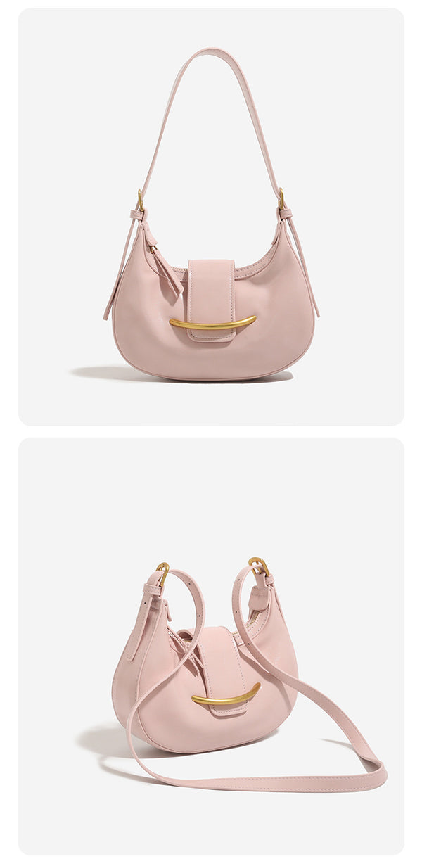 Compact crescent hobo shoulder bag with glossy synthetic finish, curved gold-tone front bar hardware, zip-top closure, and